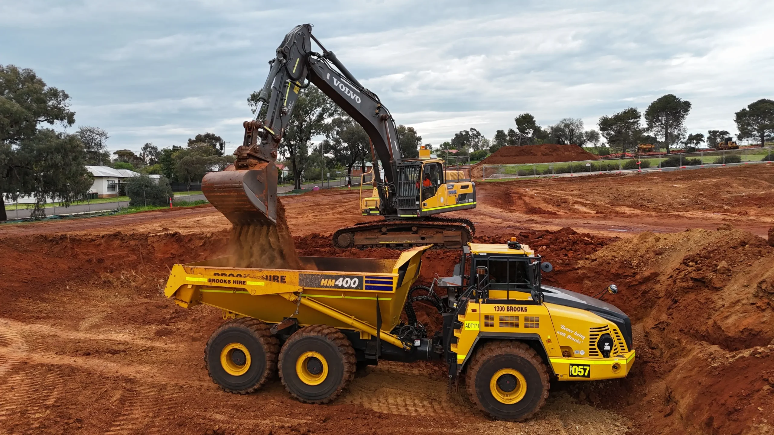 Excavator loading an articulated dump truck on a Force Civil earthworks site